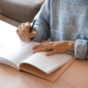 Adult writing in a planner in soft daylight, illustrating the structure and routine that support recovery for adults with ADHD