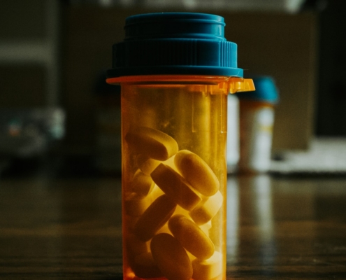 amber prescription bottle of benzodiazepine tablets on a table