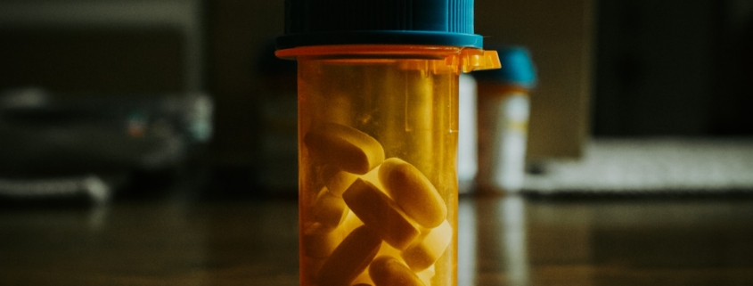 amber prescription bottle of benzodiazepine tablets on a table