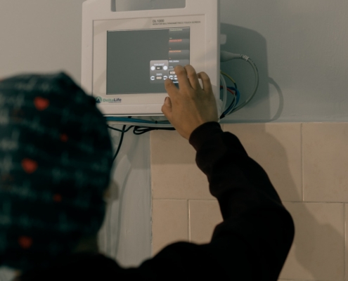 Medically monitored opioid detox in residential treatment: nurse adjusting a vital signs monitor during 24/7 withdrawal management