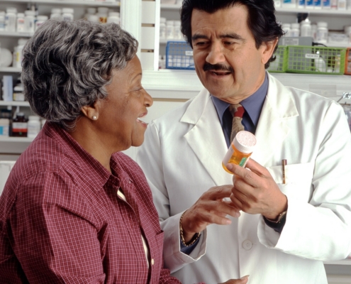 pharmacist explaining a naltrexone prescription to a patient in a residential treatment program