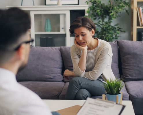 therapist meeting with a client to discuss treating OCD and addiction together