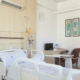private inpatient treatment room with a hospital bed and IV pole