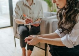 Clinician in a Los Angeles residential treatment office listening to a patient describe depression and cocaine use during a dual diagnosis assessment