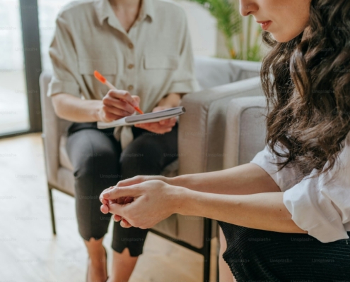 Clinician in a Los Angeles residential treatment office listening to a patient describe depression and cocaine use during a dual diagnosis assessment