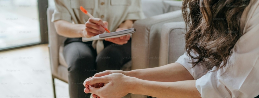 Clinician in a Los Angeles residential treatment office listening to a patient describe depression and cocaine use during a dual diagnosis assessment