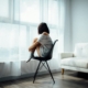 Person sitting by a window reflecting on depression after quitting alcohol