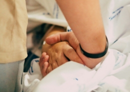 how families support a loved one during medical detox - hand holding support at bedside