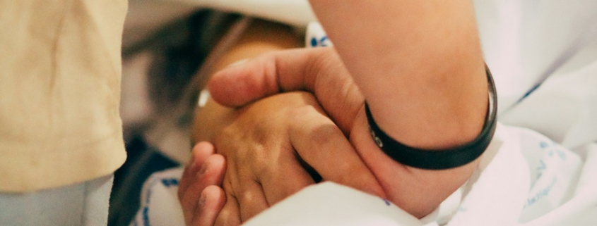 how families support a loved one during medical detox - hand holding support at bedside