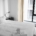 Bright, calm bedroom with a neatly made bed, illustrating restored sleep in early recovery