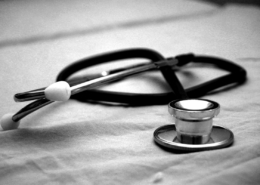 Medication-assisted treatment during residential rehab — clinician reviewing a patient medication plan in a care setting
