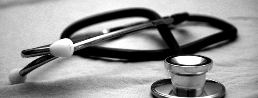 Medication-assisted treatment during residential rehab — clinician reviewing a patient medication plan in a care setting