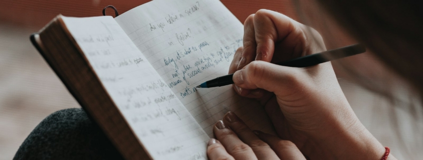 Person journaling during post-acute withdrawal recovery reflection