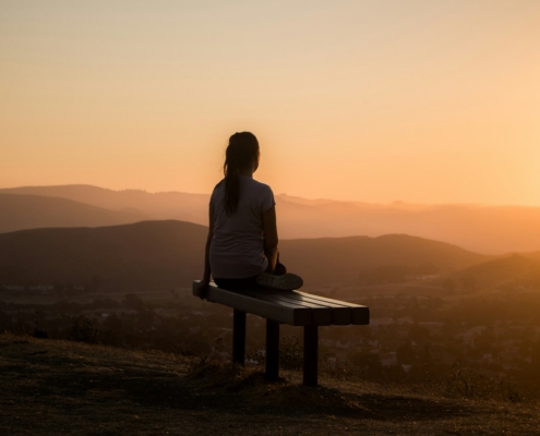 Person overlooking mountains during post-acute withdrawal recovery