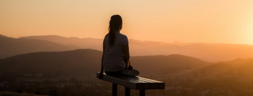 Person overlooking mountains during post-acute withdrawal recovery