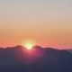Calm mountain landscape at sunrise, representing the deceptive optimism of the pink cloud in early recovery