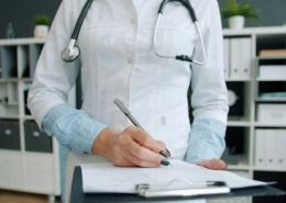 Clinician documenting a treatment plan during a PTSD and alcohol use disorder consultation at a Los Angeles residential program