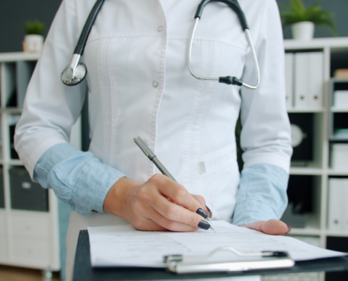 Clinician documenting a treatment plan during a PTSD and alcohol use disorder consultation at a Los Angeles residential program