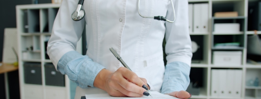 Clinician documenting a treatment plan during a PTSD and alcohol use disorder consultation at a Los Angeles residential program