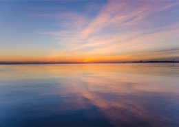Residential dual diagnosis treatment vs psychiatric hospital care, calm sunrise over still water symbolizing stabilization in Los Angeles residential treatment