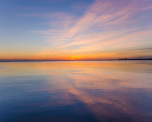 Residential dual diagnosis treatment vs psychiatric hospital care, calm sunrise over still water symbolizing stabilization in Los Angeles residential treatment