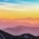 Person standing on a mountain ridge watching the sunrise, symbolizing hope and a fresh start in addiction recovery