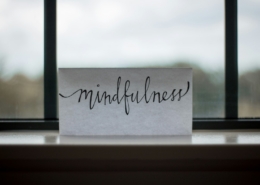 Person in a calm therapy office reflecting during a trauma-informed addiction recovery session