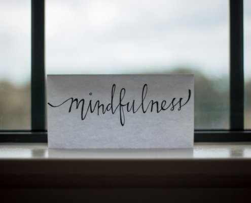 Person in a calm therapy office reflecting during a trauma-informed addiction recovery session